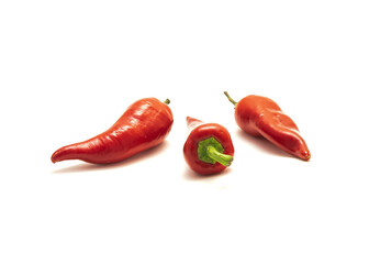 Three organic naturally ripen Fresno peppers or Fresno chili pepper isolated on white