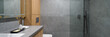Modern bathroom with shower and gray tiles, panorama