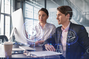 Wall Mural - Businessman and businesswoman working together to protect clients confidential information and cyber security. IT hologram padlock icons over office background with panoramic windows.