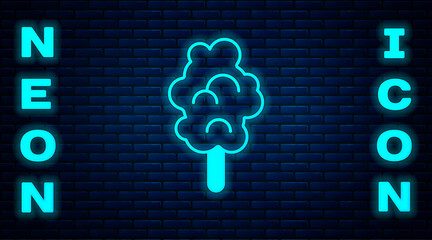 Poster - Glowing neon Cotton candy icon isolated on brick wall background. Vector