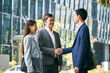 © imtmphoto - asian business associates shaking hands outdoors