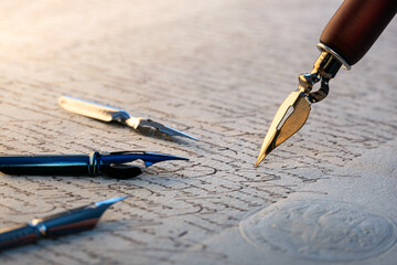 Wall Mural - Fountain pen on an antique handwritten letter. Vintage nib pen and handwritten english cursive style font copperplate, spencerian. Old history background. Retro style.