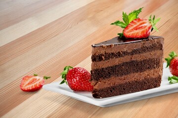 Poster - Slice of delicious chocolate cake on desk