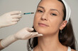 © vladimirfloyd - Portrait of a young satisfied woman on a face filler injection procedure
