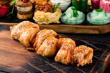 Wall Mural - Pizza Calzone folded as a patty on a wooden board table