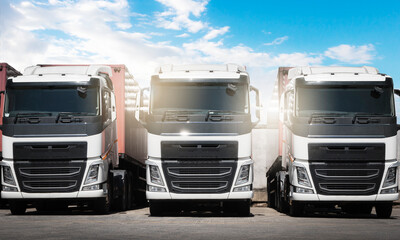 Row of Semi Trailer Trucks the Parking at Blue Sky. Industry Road Freight Truck. Logistic and Cargo Transport Concept.	