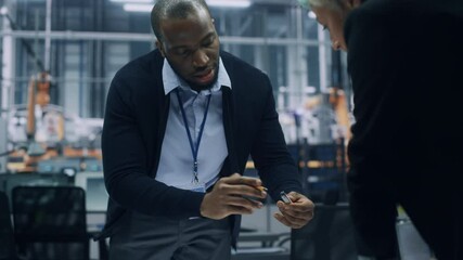 Poster - Two Young Automotive Engineers Working in Office at Car Factory. Industrial Designer and Colleague Discussing Different Applications of a Metal Pinion Gear in Personal Mobility Vehicles.