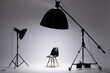 Photo studio with lighting equipment. light scheme and chair. The concept of selection and casting. Job recruitment advertisement.