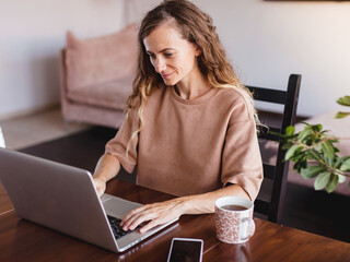 Poster - Cheerful woman using silver laptop