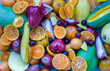 Variety of fresh assorted fruits on blue background. Assorted fruits colorful background, healthy fruits, Selective focus.