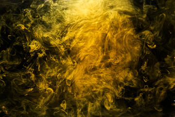 Wall Mural - Abstract liquid art, yellow smoke bomb on black background, amber color acrylic paints under water