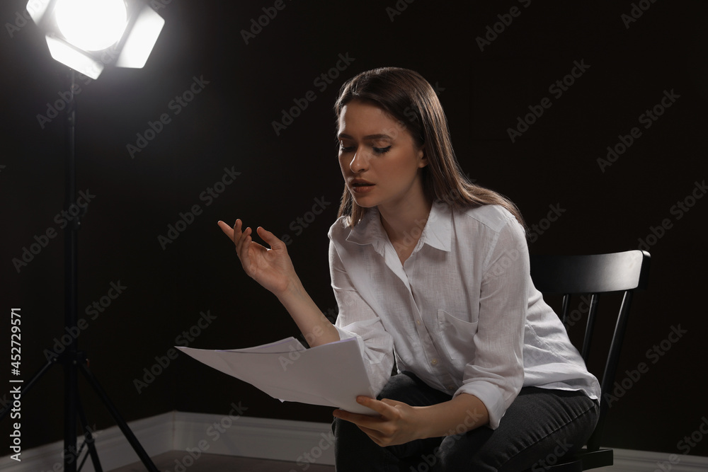 Professional actress reading her script during rehearsal in theatre ...
