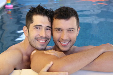 Wall Mural - Gorgeous interracial gay couple in swimming pool 