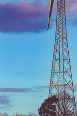 Wall Mural - Vertical shot of a power technology tower with dark blue cloudy sky