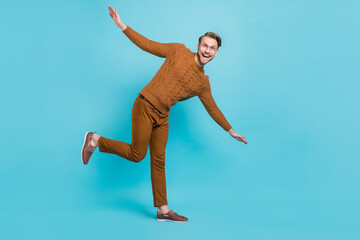 Sticker - Full body photo of charming happy young man dance hands wings smile isolated on blue color background