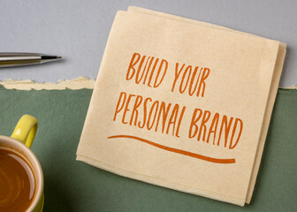 Wall Mural - Build your personal brand motivational advice - handwriting on a napkin with a cup of coffee, business and personal development concept