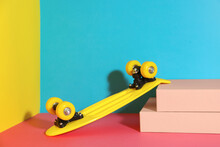 Yellow Skateboard On Color Background. Space For Text