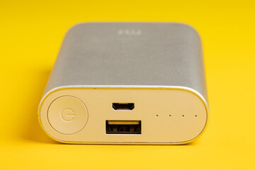 Portable power bank for charging mobile devices on yellow