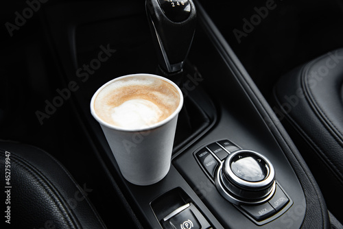 Cup of coffee in car holder.