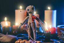Voodoo Magic Concept. Witchcraft With Voodoo Doll. Close-up Of Rag Puppet Nipped With Needles.