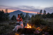 Couple by the fire at picnic in the mountains