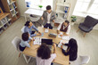 © Studio Romantic - Team of businesspeople having a discussion in a meeting. Group of young and mature business teammates sitting around table in office interior and listening to manager. View from above, high angle shot