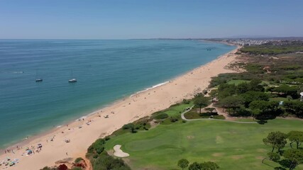 Wall Mural - Aerial video shooting of a tourist village on the Atlantic Ocean, with golf courses, Vale de Lobo. Portugal Algarve.