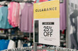 © trongnguyen - Clearance sign for 25 percent off with blurry modern women clothing at fashion store in America