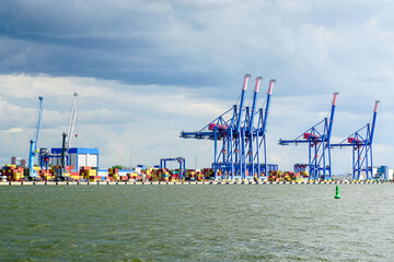 port view with sea container terminal and loading cranes