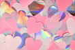 Leinwandbild Motiv Pink, white and shiny silver colored heart shaped paper confetti on light blue background