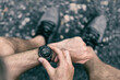 © Maridav - Smartwatch wearable smart tech fitness active athlete man using sports watch on exercise cardio workout checking his heart rate. City street with grey running shoes.