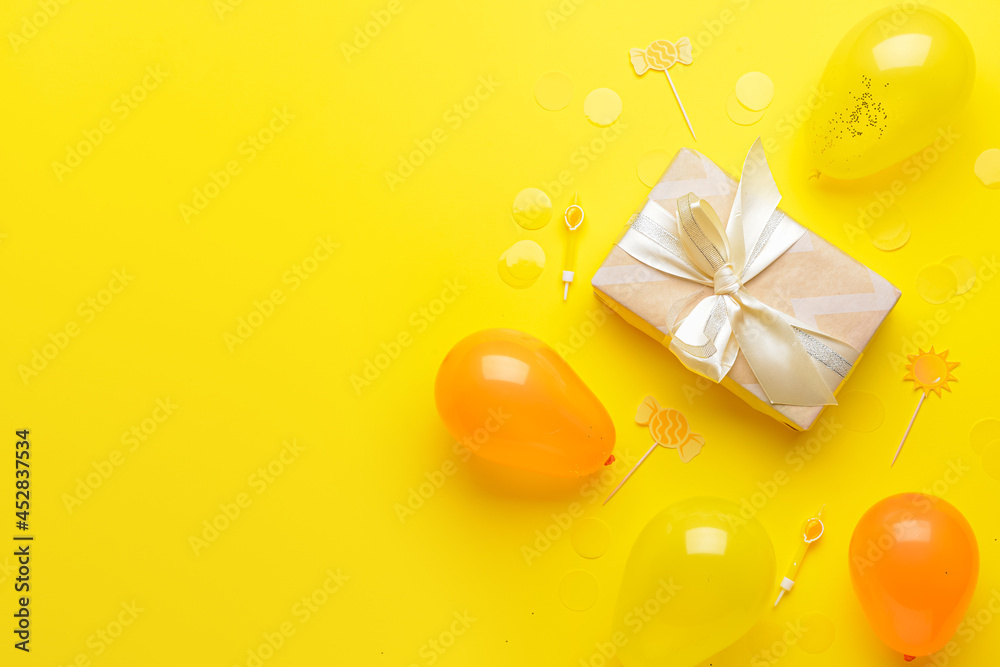Gift box, balloons and confetti on color background