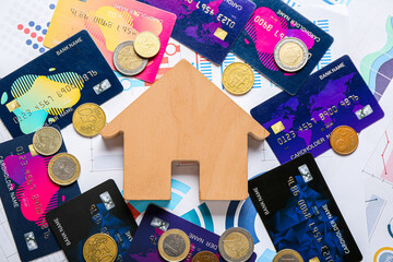 Poster - House figure with coins and credit cards on charts