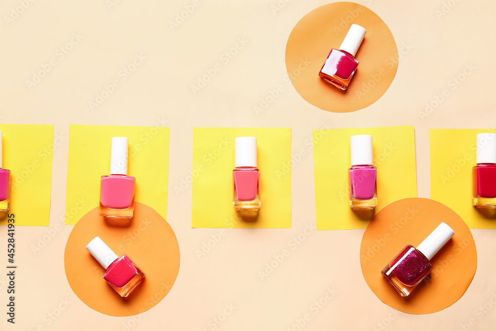 Bottles of nail polishes on color background