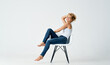 © SHOTPRIME STUDIO - attractive woman sitting on a chair in jeans movement emotions posing