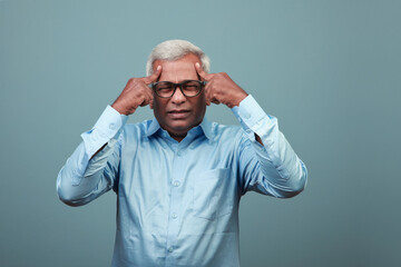 Wall Mural - Elderly man of Indian origin feeling head ache