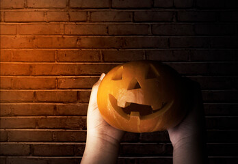 Wall Mural - Hand holding Jack-o-Lantern