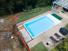 Aerial Drone Flight Of Pool Build Construction Site With Pool Filled With Water In A Garden