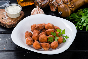 Wall Mural - Traditional fried pelmeni, ravioli, dumplings filled with meat on black background, copy space.