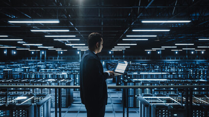 Aufkleber - Data Center Male Administrator Using Laptop Computer. Maintenance Specialis working in Cloud Computing Facility on Cyber Security and Network Protection. Server Farm Analytics. Medium Wide