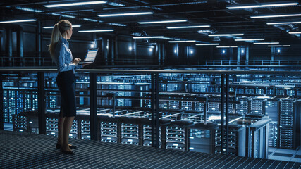 Fototapete - Data Center Female It Specialist Using Laptop. Server Farm Cloud Computing and Cyber Security Maintenance Administrator Running Diagnostics on Computer. Information Technology Professional.