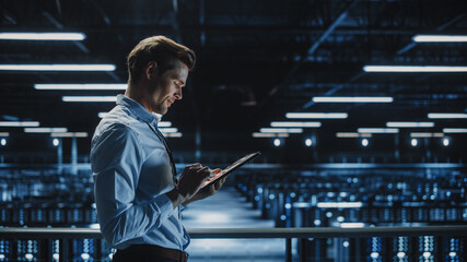 Leinwandbilder - Handsome Smiling IT Specialist Using Tablet Computer in Data Center. Succesful Businessman and e-Business Entrepreneur Overlooking Server Farm Cloud Computing Facility.