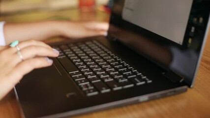 Wall Mural - close up of woman touching laptop fingerprint sensor with her finger to login. biometric fingerprint