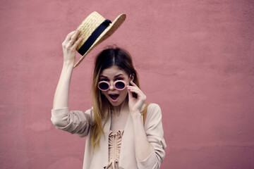 Poster - beautiful woman on the street wearing hat and glasses pink wall model