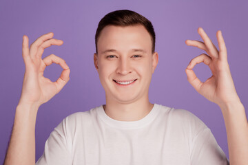 Wall Mural - Portrait of cheerful man show okey signs on violet background