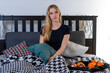 © ako-photography - young blonde woman having breakfast in bed, drinking coffee and eating fruit