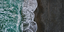 Sea Shore With Dramatic Texture Of Breaking Waves And Black Sand, Drone Perspective