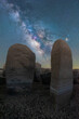 Megalithic monuments under starry sky with Milky Way