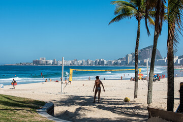 Wall Mural - Walking through the beautiful beach of Copacabana