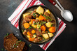 © Светлана Монякова - Traditional Irish stew in a black bowl on a dark background. Stew of lamb, potatoes, onions, carrots, and thyme. Traditional dish of St. Patrick's Day.